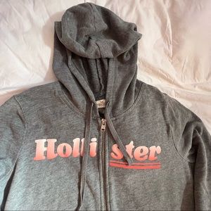 HOLLISTER • GREY ZIP UP SWEATSHIRT WITH PINK OMBRÉ LOGO